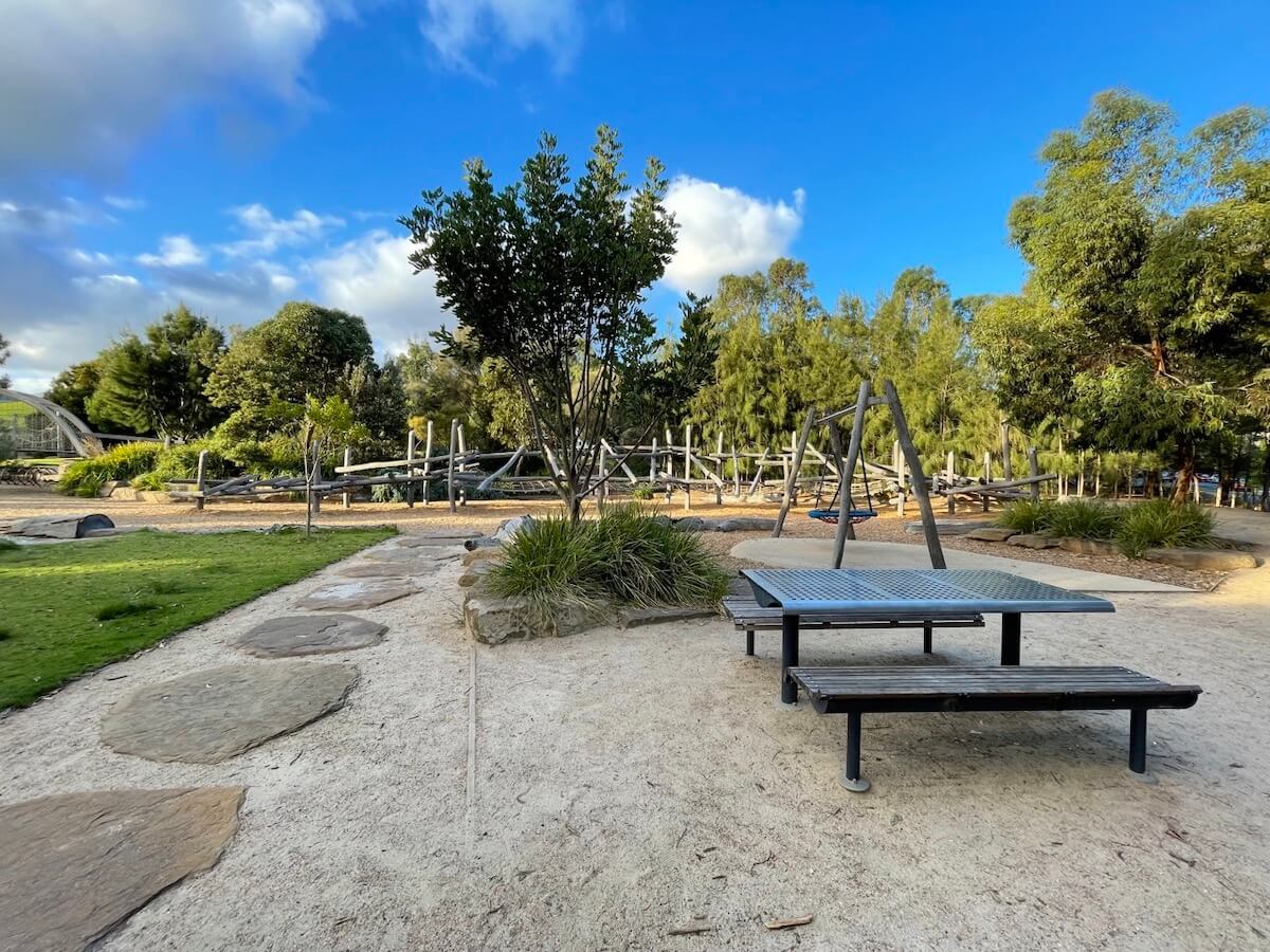 Nature play and picnic tables at Royal Park Playground.